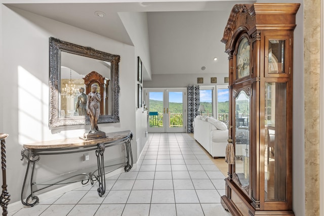 33 Lakeview Ln, Harrison, ME 04040 - hall featuring french doors, light tile patterned floors, and a chandelier