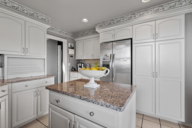 33 Lakeview Ln, Harrison, ME 04040 - kitchen featuring stainless steel fridge with ice dispenser, light tile patterned floors, dark stone countertops, recessed lighting, and a center island