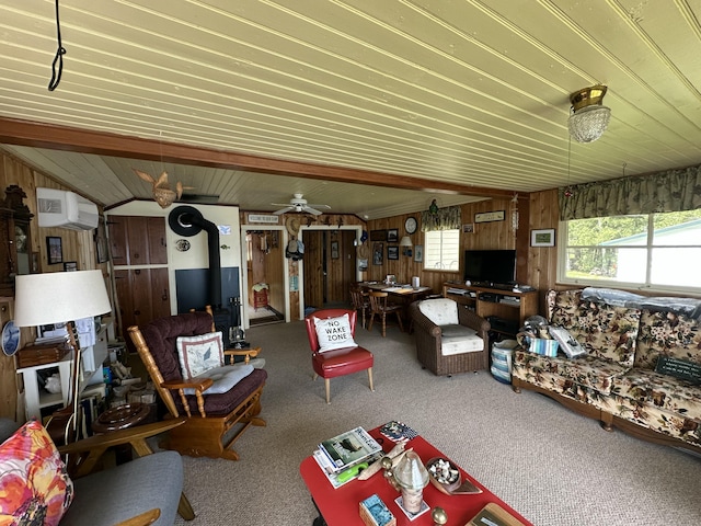 50 Forget Me Not Ln, Orient, ME 04471 - living area with a wood stove, wooden walls, a wall mounted air conditioner, carpet flooring, and wooden ceiling