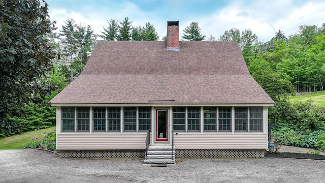 370 Center Conway Rd, Brownfield, ME 04010 - view of front facade featuring entry steps, a sunroom, a shingled roof, and a chimney