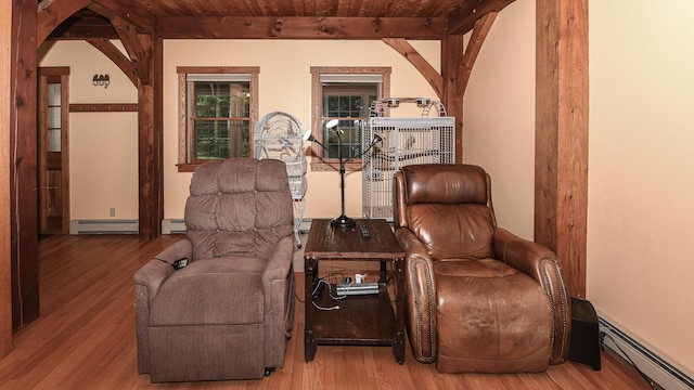 370 Center Conway Rd, Brownfield, ME 04010 - sitting room with a baseboard radiator, wood finished floors, a wooden ceiling with exposed beams, and arched walkways