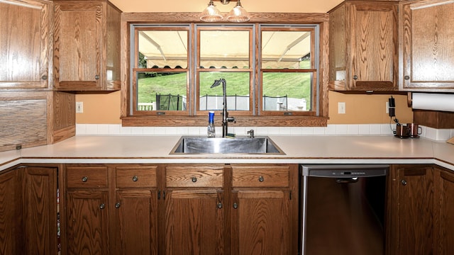 370 Center Conway Rd, Brownfield, ME 04010 - kitchen featuring dishwashing machine, brown cabinetry, and light countertops