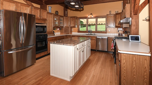 370 Center Conway Rd, Brownfield, ME 04010 - kitchen featuring black appliances, beamed ceiling, brown cabinets, light wood finished floors, and exhaust hood