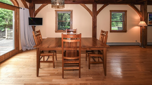 370 Center Conway Rd, Brownfield, ME 04010 - dining area with hardwood / wood-style flooring, baseboard heating, and arched walkways