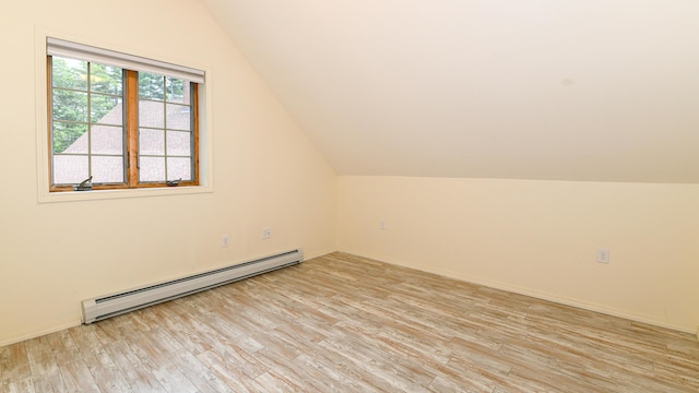 370 Center Conway Rd, Brownfield, ME 04010 - additional living space with a baseboard radiator, light wood-type flooring, and vaulted ceiling
