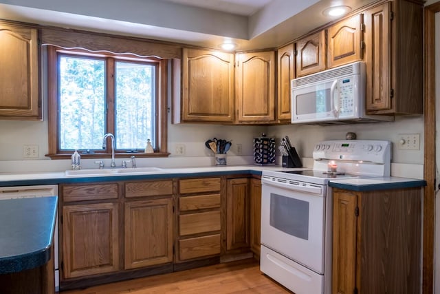 9 Kennebec Cir, Bath, ME 04530 - kitchen featuring white appliances, brown cabinetry, light wood-style floors, and light countertops