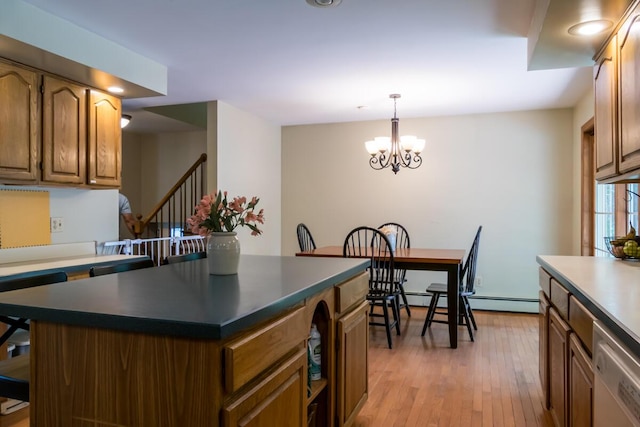 9 Kennebec Cir, Bath, ME 04530 - kitchen featuring dishwashing machine, light wood-style flooring, a chandelier, brown cabinets, and dark countertops