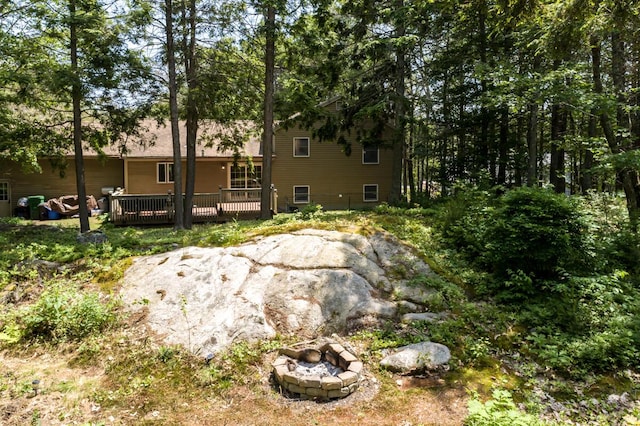 9 Kennebec Cir, Bath, ME 04530 - back of property featuring a wooden deck and a fire pit
