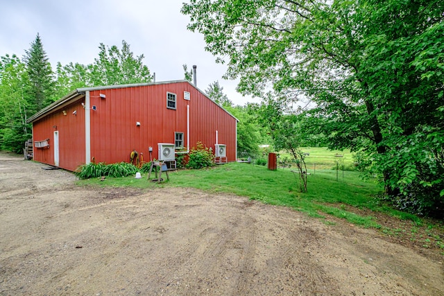 41 Dundee Rd, Albany Twp, ME 04217 - view of property exterior featuring a pole building, an outdoor structure, a detached garage, and a lawn