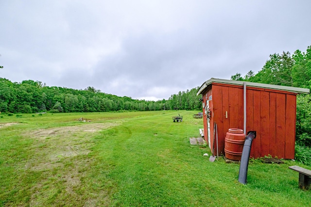 41 Dundee Rd, Albany Twp, ME 04217 - view of green lawn featuring an outdoor structure and a wooded view