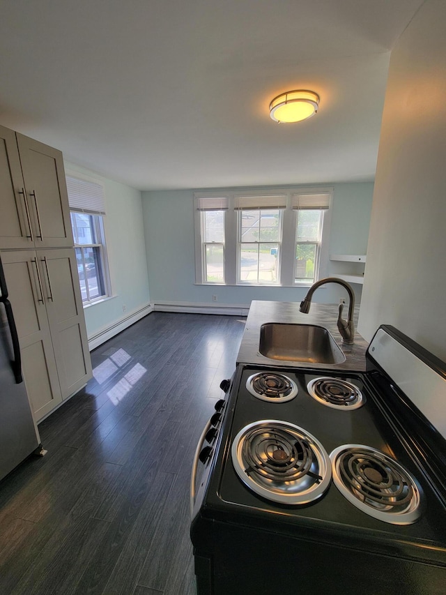 59 Washington St, Biddeford, ME 04005 - kitchen featuring range with electric stovetop, healthy amount of natural light, and dark wood-style flooring