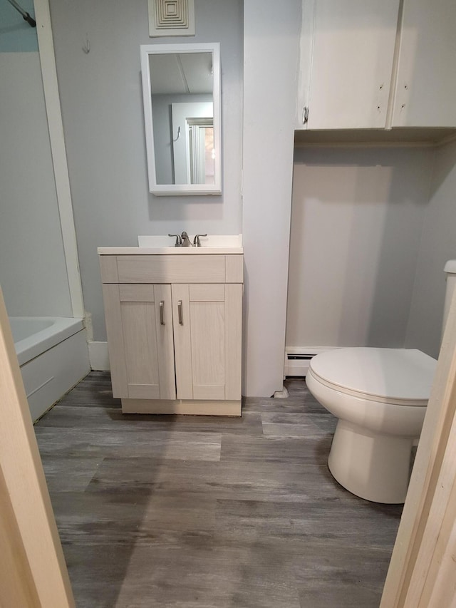 59 Washington St, Biddeford, ME 04005 - full bath featuring vanity, wood finished floors, a tub to relax in, and a shower