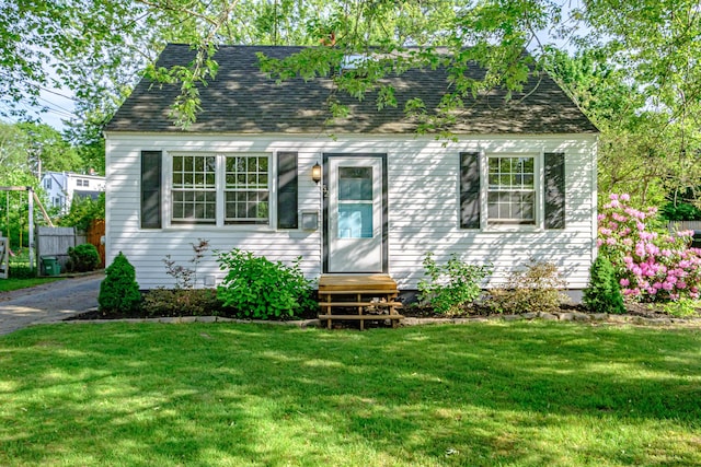 52 Mckinley St, South Portland, ME 04106 - new england style home with a front lawn, roof with shingles, and entry steps
