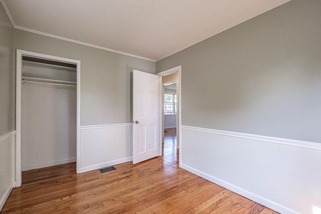 52 Mckinley St, South Portland, ME 04106 - unfurnished bedroom featuring wood finished floors, crown molding, and a closet