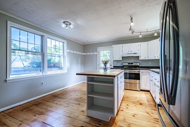 52 Mckinley St, South Portland, ME 04106 - kitchen with stainless steel electric stove, butcher block countertops, freestanding refrigerator, open shelves, and under cabinet range hood