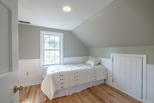 52 Mckinley St, South Portland, ME 04106 - bedroom with wainscoting, wood finished floors, and lofted ceiling