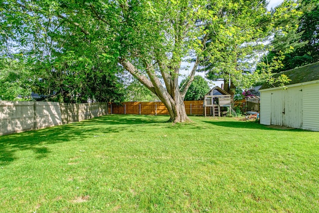 52 Mckinley St, South Portland, ME 04106 - fenced backyard with a playground and an outdoor structure