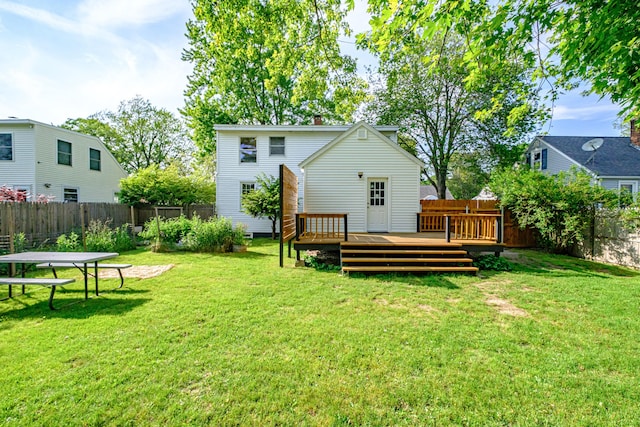 52 Mckinley St, South Portland, ME 04106 - rear view of property with a fenced backyard, a wooden deck, and a chimney