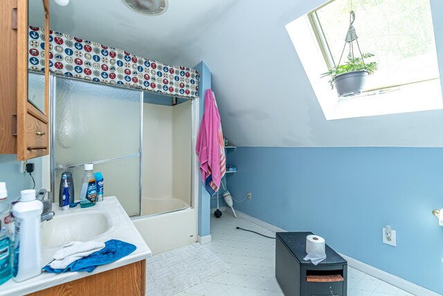 37 Paul St, York, ME 03909 - full bathroom featuring lofted ceiling, vanity, tile patterned floors, and a skylight