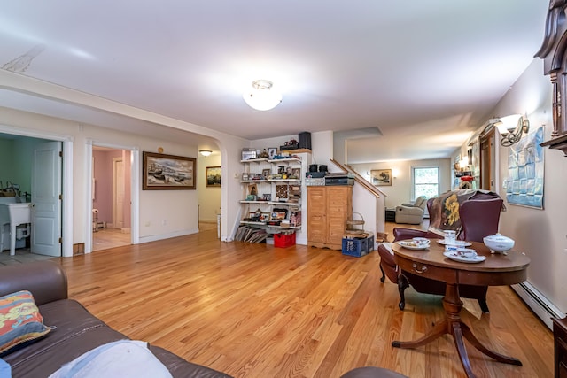 37 Paul St, York, ME 03909 - living area featuring light wood-style floors, a baseboard heating unit, and stairs