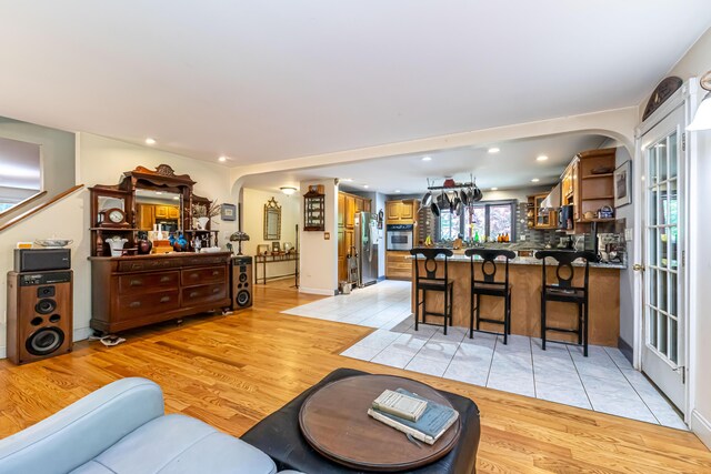 37 Paul St, York, ME 03909 - living room featuring light wood-style floors, arched walkways, and recessed lighting