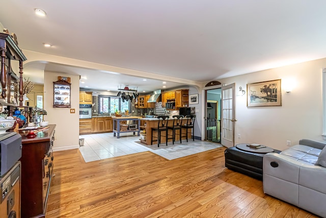 37 Paul St, York, ME 03909 - living room featuring arched walkways, light wood-type flooring, and recessed lighting