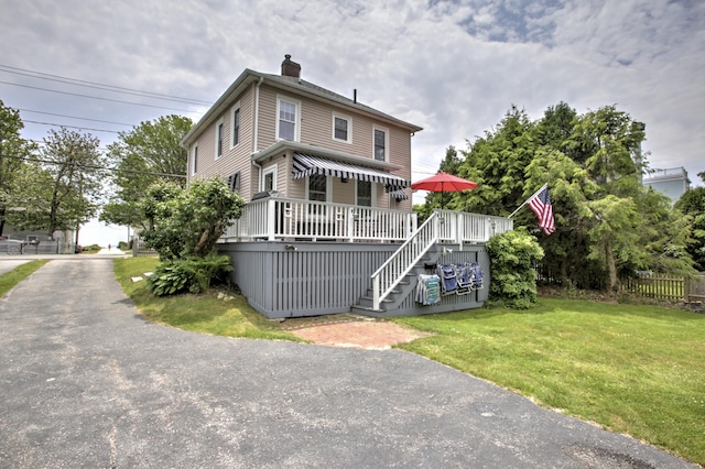 23 E Grand Ave, Scarborough, ME 04074 - view of front of house with stairway, a chimney, and a deck