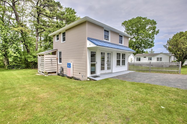 23 E Grand Ave, Scarborough, ME 04074 - rear view of house with french doors, a metal roof, asphalt driveway, a patio, and a standing seam roof