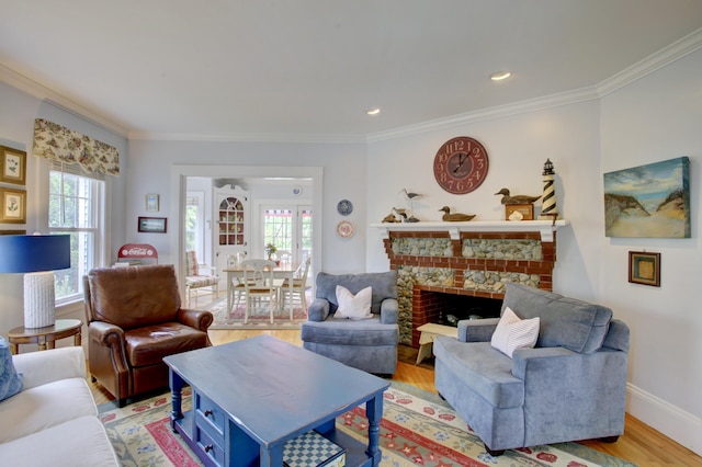 23 E Grand Ave, Scarborough, ME 04074 - living room with ornamental molding, light wood-style flooring, a stone fireplace, and recessed lighting