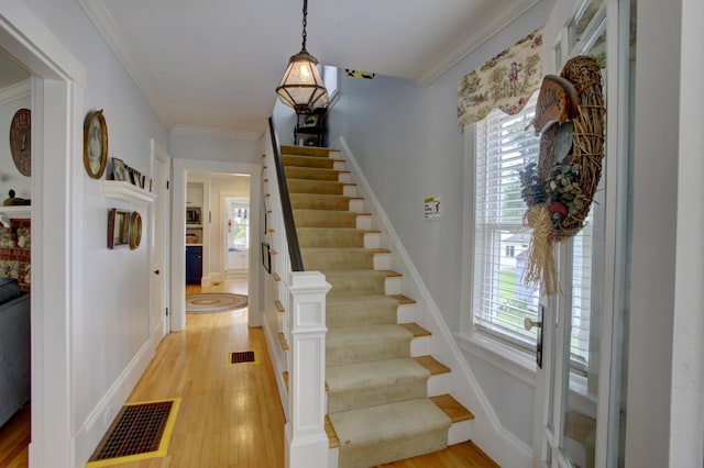23 E Grand Ave, Scarborough, ME 04074 - stairs with plenty of natural light, wood finished floors, and crown molding