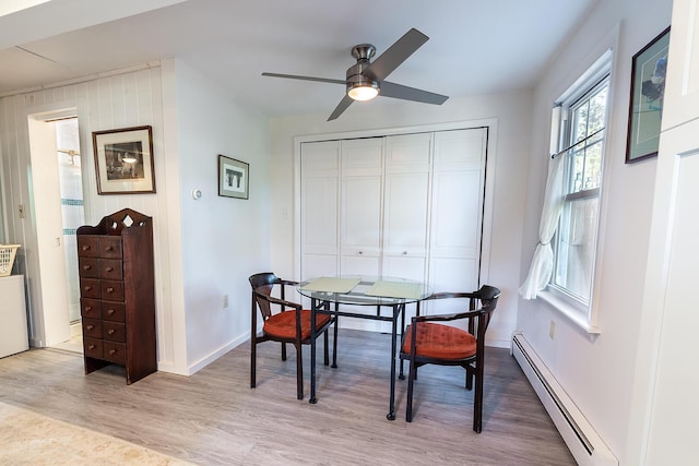 82 Park Ave, Old Orchard Beach, ME 04064 - dining space featuring a baseboard radiator, ceiling fan, and light wood finished floors