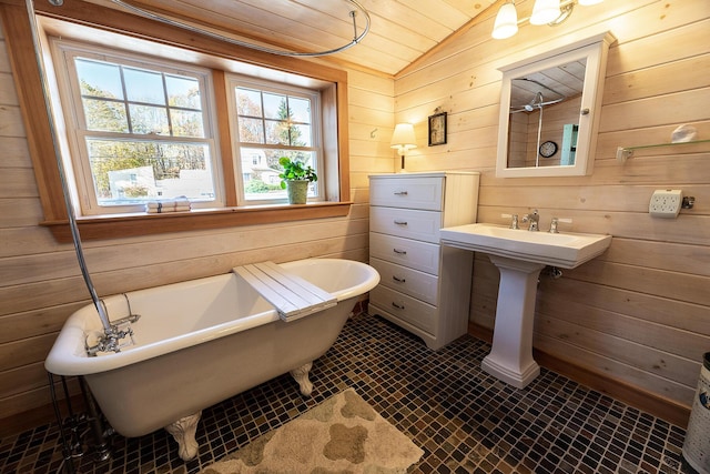 82 Park Ave, Old Orchard Beach, ME 04064 - bathroom featuring lofted ceiling, wooden walls, wooden ceiling, and a freestanding tub