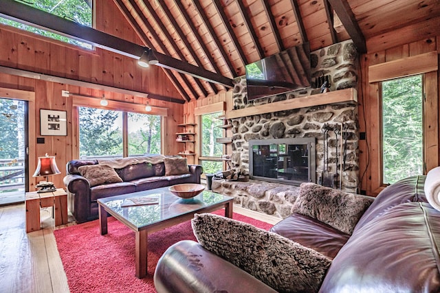 34 Alpine Shores Rd, Woodstock, ME 04219 - living room with wooden walls, hardwood / wood-style floors, a wood ceiling with exposed beams, high vaulted ceiling, and a fireplace