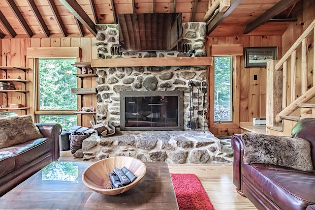 34 Alpine Shores Rd, Woodstock, ME 04219 - living area with a wood ceiling with exposed beams, wooden walls, wood finished floors, and a fireplace