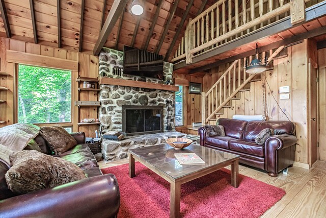 34 Alpine Shores Rd, Woodstock, ME 04219 - living area featuring wooden walls, a wood ceiling with exposed beams, wood finished floors, high vaulted ceiling, and stairway