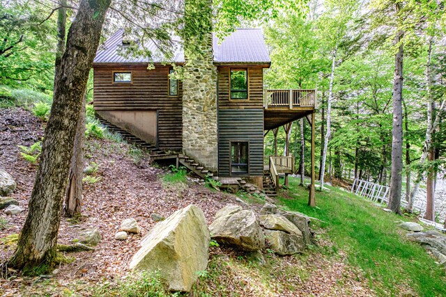 34 Alpine Shores Rd, Woodstock, ME 04219 - rear view of house with stairway, a deck, log veneer siding, and a metal roof