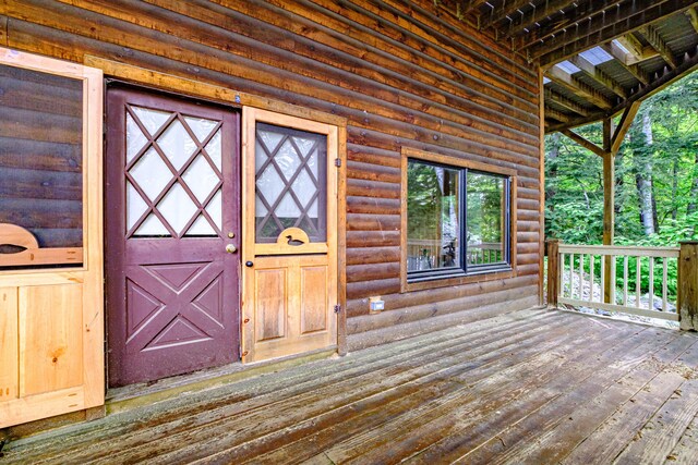 34 Alpine Shores Rd, Woodstock, ME 04219 - property entrance with faux log siding and a deck
