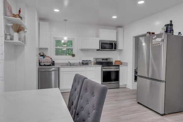 62 Seventh St, Auburn, ME 04210 - kitchen featuring appliances with stainless steel finishes, open shelves, white cabinetry, light wood-style flooring, and recessed lighting