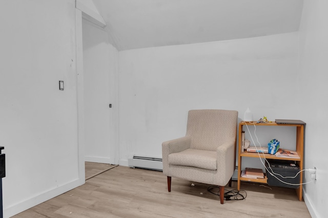 62 Seventh St, Auburn, ME 04210 - living area featuring baseboard heating, wood finished floors, and vaulted ceiling