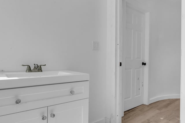 62 Seventh St, Auburn, ME 04210 - bathroom with wood finished floors and vanity