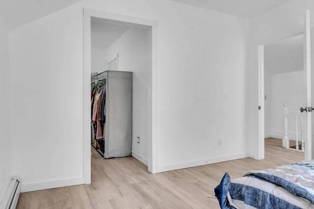 62 Seventh St, Auburn, ME 04210 - bedroom featuring a baseboard radiator, light wood-style flooring, and a spacious closet