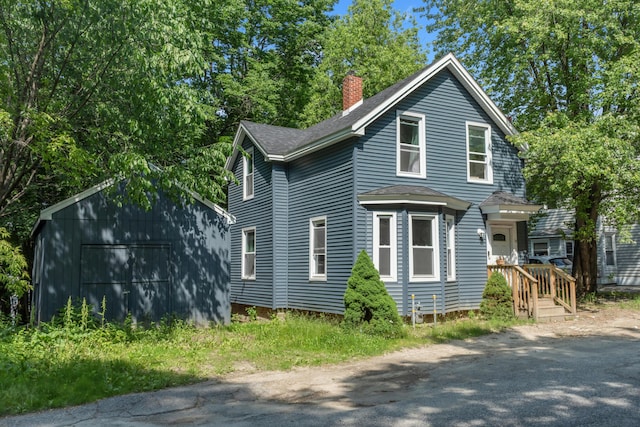 62 Seventh St, Auburn, ME 04210 - view of side of property with a chimney, an outdoor structure, and roof with shingles