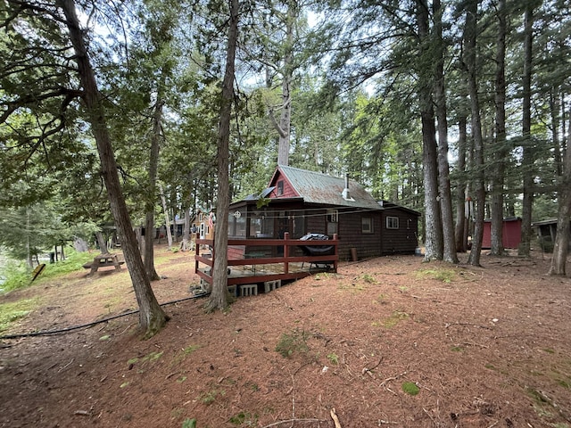 23 Webber Is, Sebec, ME 04481 - rear view of property featuring a deck and a metal roof