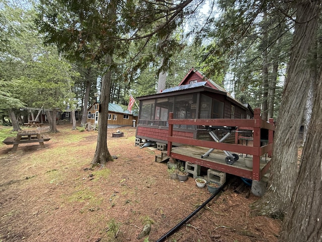 23 Webber Is, Sebec, ME 04481 - view of yard featuring a sunroom and view of scattered trees