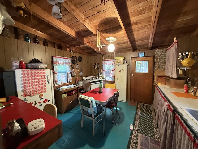 23 Webber Is, Sebec, ME 04481 - kitchen featuring a wooden ceiling with exposed beams, freestanding refrigerator, and wood walls