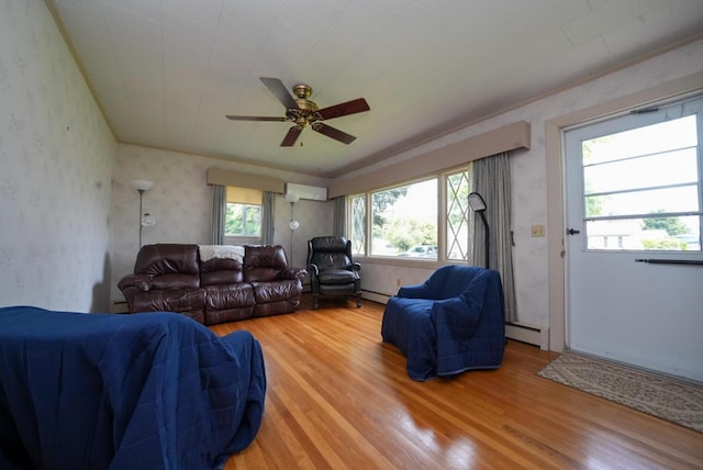 12 Davis Dr, Veazie, ME 04401 - living area with light wood-style floors, an AC wall unit, a ceiling fan, a baseboard radiator, and wallpapered walls