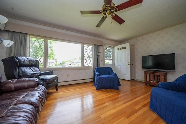 12 Davis Dr, Veazie, ME 04401 - living room featuring a baseboard heating unit, wallpapered walls, light wood-style flooring, and a ceiling fan