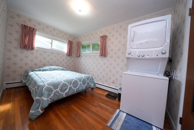 12 Davis Dr, Veazie, ME 04401 - bedroom featuring stacked washing machine and dryer, wood finished floors, baseboard heating, wallpapered walls, and ornamental molding