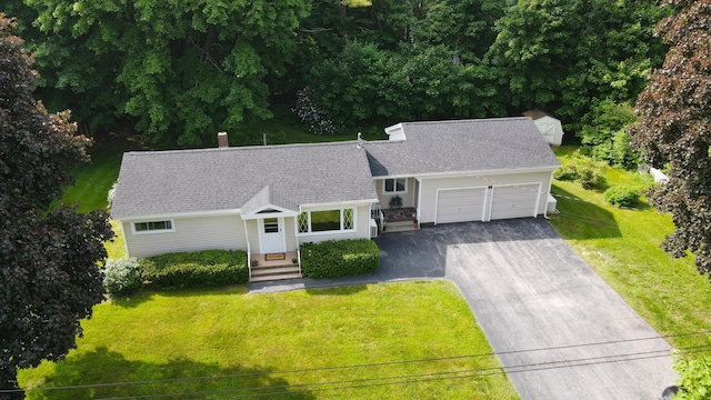 12 Davis Dr, Veazie, ME 04401 - view of front facade featuring driveway, a garage, a front lawn, roof with shingles, and a chimney