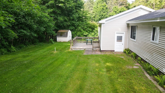 12 Davis Dr, Veazie, ME 04401 - view of green lawn with a storage shed and a wooden deck